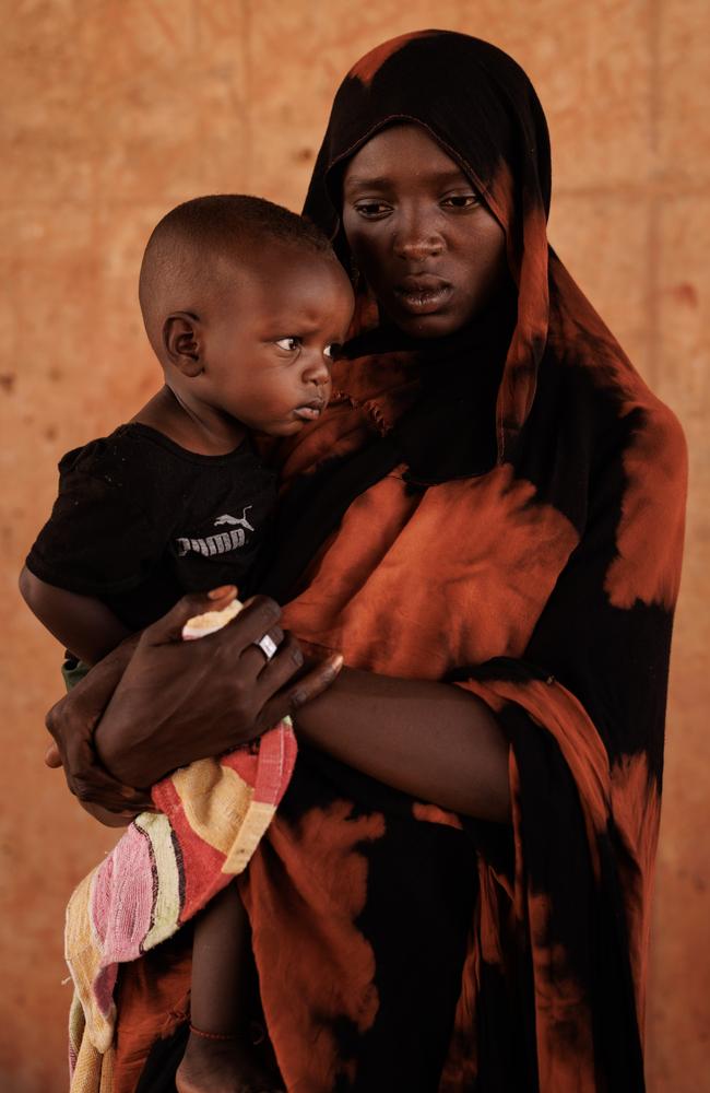 Kobra Yagoub-Sharaf with her daughter Eldin from Darfur on the Chad Sudan border after having their documents processed. Over 600,000 new refugees have crossed the border from Darfur in Sudan, into Chad in the past year. Picture: Dan Kitwood/Getty Images