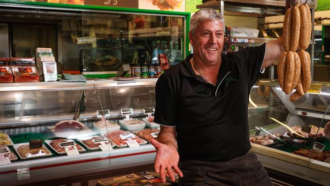 Fannie Bay Butcher owner Terry Wilkins with his laksa gourmet snags. Picture: Glenn Campbell