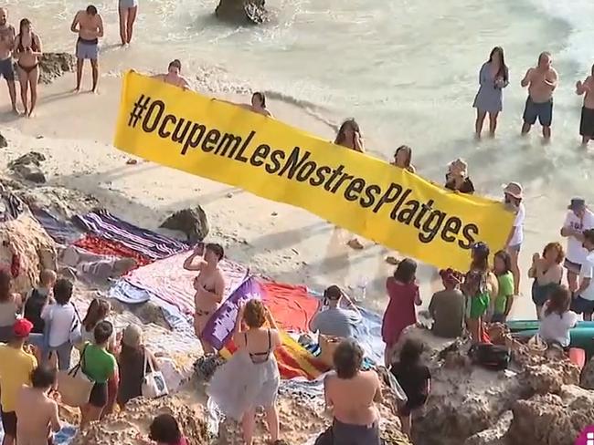 Majorcans block tourists from local beach. Picture: IB3 NOTÍCIES