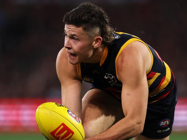 ADELAIDE, AUSTRALIA - MAY 02: Jake Soligo of the Crows handpasses the ball during the 2024 AFL Round 08 match between the Adelaide Crows and the Port Adelaide Power at Adelaide Oval on May 02, 2024 in Adelaide, Australia. (Photo by James Elsby/AFL Photos via Getty Images)