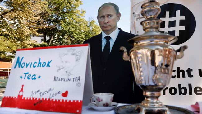 A mock offer of ‘Novichok Tea’ is seen in front of an effigy of Russian President Vladimir Putin outside the Russian embassy in Berlin during a protest on Wednesday. Picture: AFP