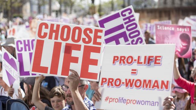 Protesters hold placards during an anti-abortion rally in Brisbane. Picture: AAP / Glenn Hunt