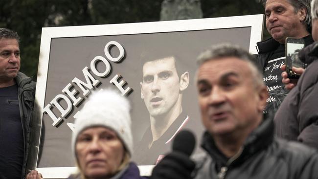 Srdjan Djokovic (R) speaks flanked by his wife Dijana (L), as they take part in a rally in front of Serbia's National Assembly, in Belgrade for their son. Picture: AFP