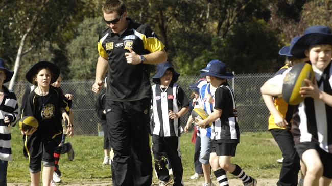 Children warm up before a school clinic.