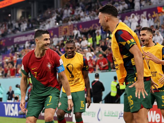 DOHA, QATAR - NOVEMBER 24: Cristiano Ronaldo of Portugal celebrates after scoring their team's first goal via a penalty with his team mates during the FIFA World Cup Qatar 2022 Group H match between Portugal and Ghana at Stadium 974 on November 24, 2022 in Doha, Qatar. (Photo by Clive Brunskill/Getty Images)