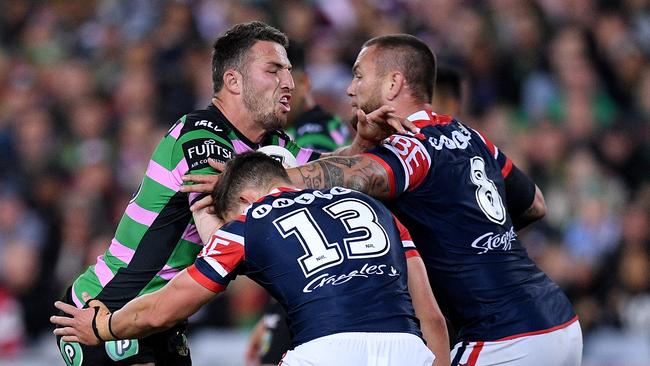 Sam Burgess of the Rabbitohs is tackled by Victor Radley (left) and Jared Waerea-Hargreaves of the Roosters during the Round 22 NRL match between the South Sydney Rabbitohs and the Sydney Roosters at ANZ Stadium in Sydney, Friday, August 10, 2018. (AAP Image/Dan Himbrechts) NO ARCHIVING, EDITORIAL USE ONLY