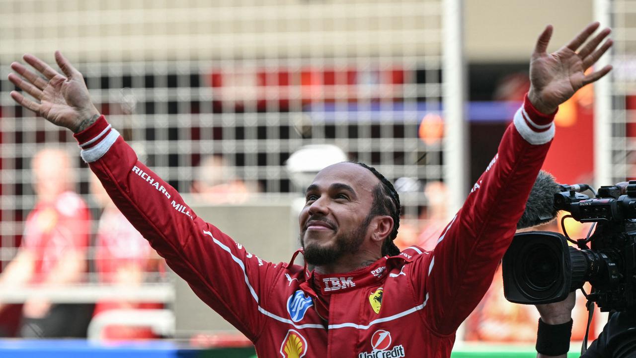 British driver Lewis Hamilton celebrates his first win with Ferrari