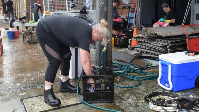 Trudy Blanch begins the flood clean up with her husband Alan at The Bunker Health and Fitness on Ballina Road Picture: Nicholas Rupolo.