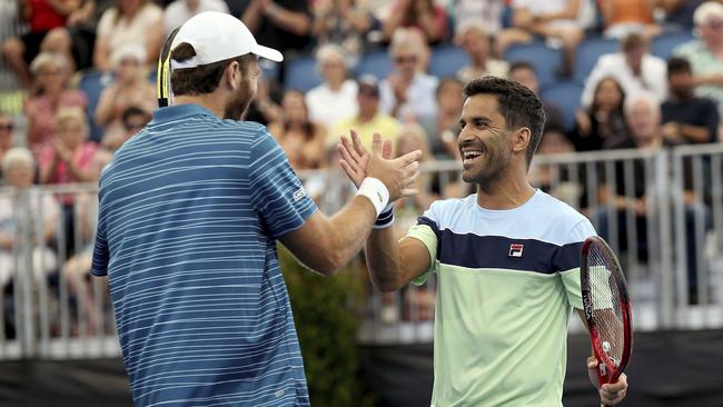 Argentine Maximo Gonzalez, right, and France's Fabrice Martin, left, celebrate their win over Croatian Ivan Dodig and Slovakian Filip Polasek during their Adelaide International tennis match in Adelaide, Saturday, Jan. 18, 2020. Picture: AP Photo/James Elsby.