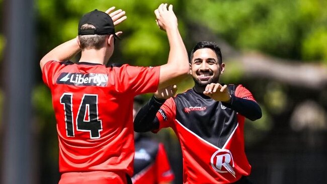 Renegades recruit Ab Das (right) high fives Jack Prestwidge after taking a wicket against the PNG. Picture: NT Cricket