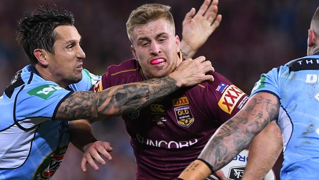 Maroons five-eighth Cameron Munster takes on the Blues defence.