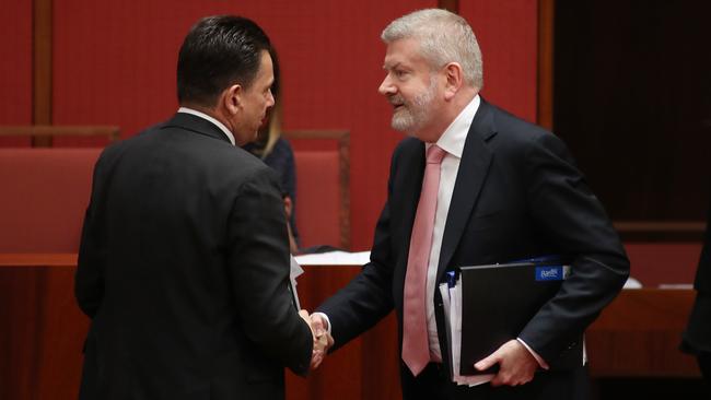 Senator Nick Xenophon and Communications Minister Senator Mitch Fifeld after the vote yesterday. Picture: Gary Ramage