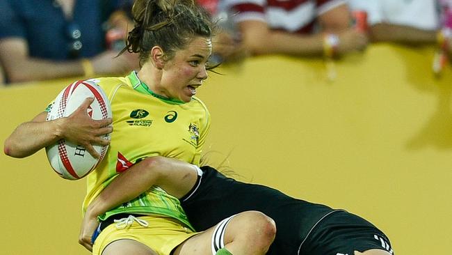 Chloe Dalton of Australia is tackled by Michaela Blyde of New Zealand.