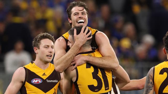 Milestone man Isaac Smith embraces Ricky Henderson during his 200th game. Picture: Paul Kane/Getty Images.