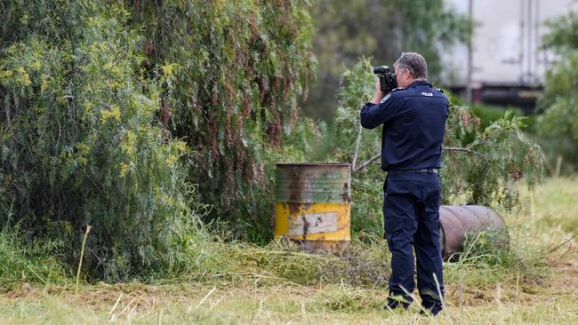 Police search through trees in a vacant paddock on Cheviot Rd in Salisbury South where parts of Mr McLean’s remains here found in October last year. Picture: Brenton Edwards