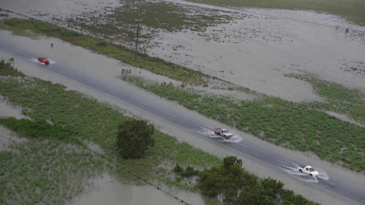 Cars travelling north on the Bruce Highway, around the Goorganga Plains, just south of Proserpine which has been surrounded by water after heavy rain. Photo Lee Constable / Daily Mercury