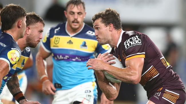 Corey Oates charges into the Titans’ defence. Picture: Chris Hyde/Getty Images