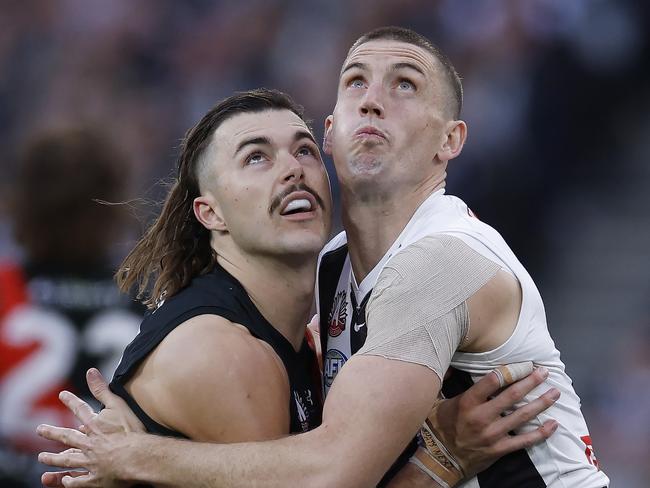 MELBOURNE , AUSTRALIA. April 25, 2024.  AFL.. Anzac Day.  Essendon vs Collingwood at the the MCG.   Sam Draper of the Bombers and Darcy Cameron of the Magpies battle   . Pic: Michael Klein
