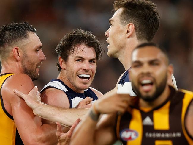 MELBOURNE, AUSTRALIA - APRIL 18: Isaac Smith of the Cats and Jack Gunston of the Hawks clash during the 2022 AFL Round 05 match between the Hawthorn Hawks and the Geelong Cats at the Melbourne Cricket Ground on April 18, 2022 In Melbourne, Australia. (Photo by Michael Willson/AFL Photos via Getty Images)