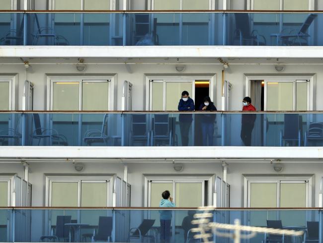 Passengers speak on balconies of the quarantined Diamond Princess cruise ship docked at a port in Yokohama, near Tokyo. Picture: AP