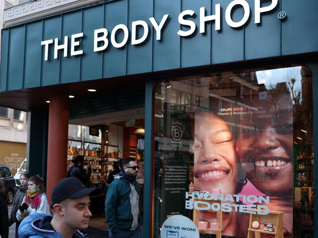 Pedestrians walk bas a branch of The Body Shop in central London on February 12, 2024. The Body Shop, the near 50-year-old cosmetics company renowned for its ethical hair and skin products, is near bankrupt in the UK after poor Christmas trade, according to reports in British media. (Photo by Daniel LEAL / AFP)