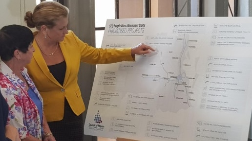 Acting mayor Cherie Dalley listens as Redland mayor Karen Williams shows her the transport upgrade plans. 