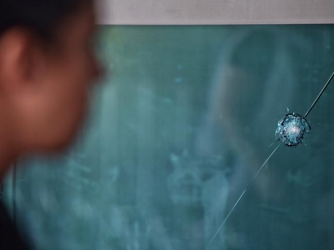 A man walks past the bullet holes remain at Turkey's largest airport, Istanbul Ataturk. Picture: Getty