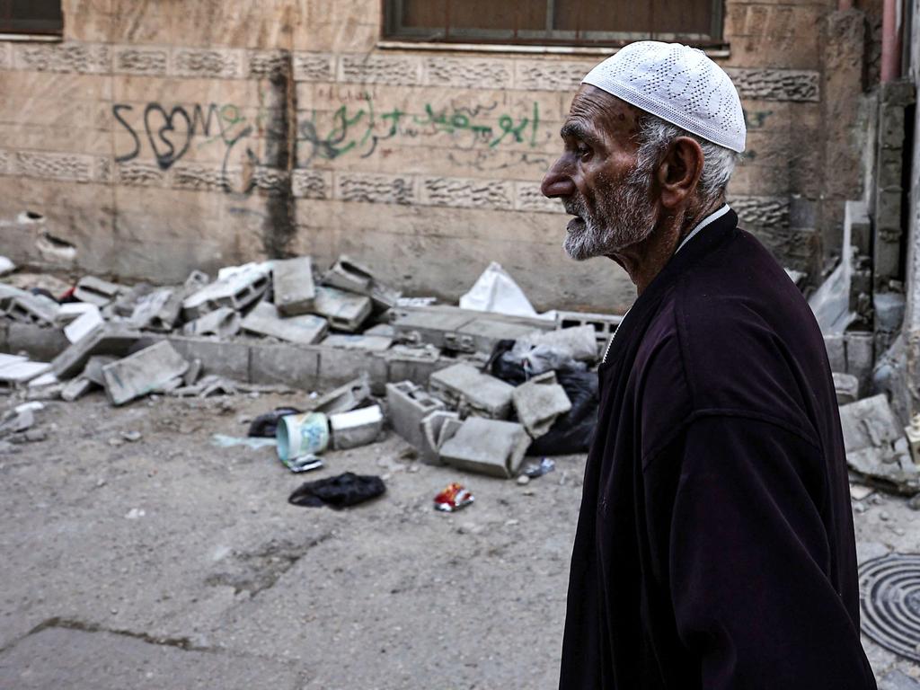 A Palestinian man walks past damage on a street in the aftermath of an Israeli raid at the Balata refugee camp, east of Nablus in the occupied West Bank. Picture: AFP