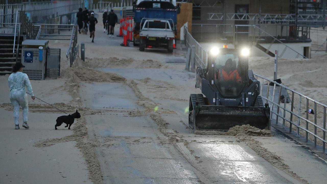 Layers of sand have blanketed the main beachfront walkway at Bondi Beach. Picture: John Grainger