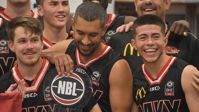 Hayden Wicks, Chris Cedar and Ansett junior Freddy Webb celebrate their NBL1 North triumph over Cairns Marlins. Picture: Matthew Forrest