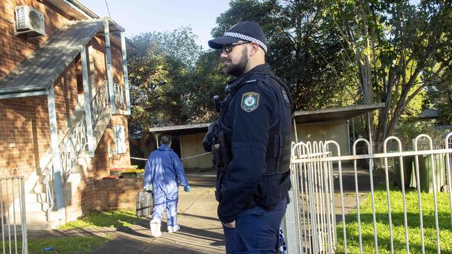 Police and forensic teams set up crime scene where a mans body was discovered in an apartment in Auburn. Picture: NewsWire / Jeremy Piper