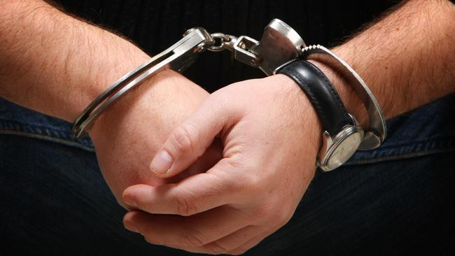 Busted - Man wearing handcuffs Source : Thinkstock