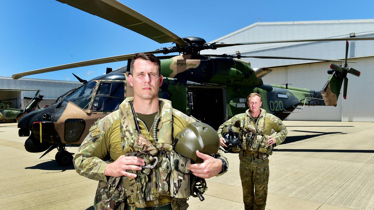 CAPT Leon Botham and SGT Kieran Dan in front of a MRH-90 Taipan at Townsville RAAF Base. Picture: Shae Beplate.