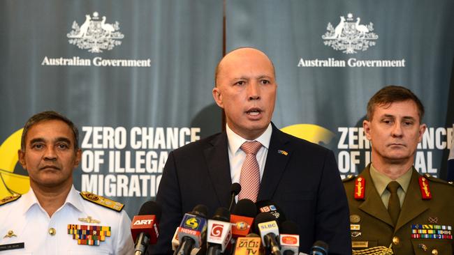 Australia's Home Minister Peter Dutton (C) speaks to the media as Sri Lanka's navy commander Piyal De Silva (L), and the head of Australia's Operation Sovereign Borders Major General Craig Furini (R) look on in Colombo on June 4, 2019. - Australia On June 4 launched a fresh initiative in Sri Lanka to discourage would-be illegal immigrants following an uptick in people- smuggling attempts last month. Home Minister Peter Dutton told reporters in Colombo that there was an increase in the number of attempts to illegally enter Australia by boat in the past month, but no one was successful. (Photo by STR / AFP)