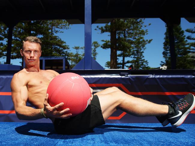 Peter Day during the Russian Twist at the F45 playoffs at Manly Beach. Picture: Braden Fastier