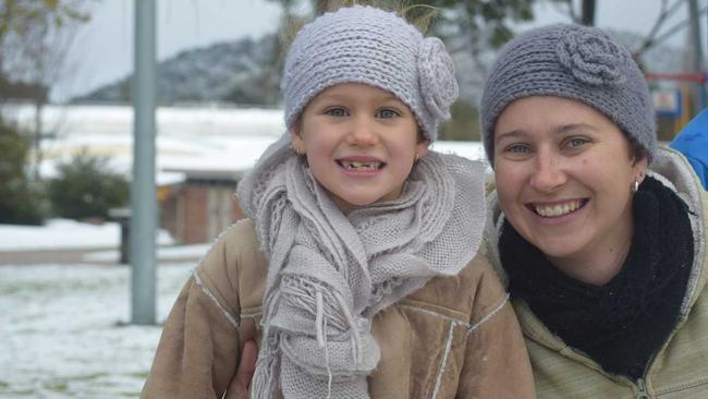 Stanthorpe locals Tammy and Ruby Brady playing in the snow at Weeroona Park. 