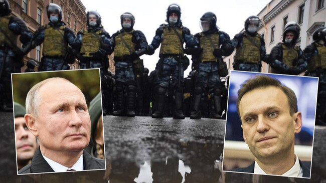 Riot police block protesters (main picture) during a rally in support of jailed opposition leader Alexei Navalny (inset right) in Saint Petersburg. Navalny, 44, is seen as the biggest threat to Vladimir Putin's leadership. Pictures: AFP