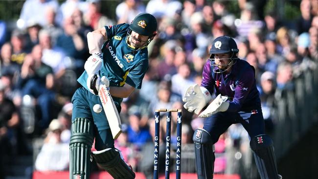 Australia's Travis Head (L) hits a six in front of Scotland's wicketkeeper Matthew Cross during the first Twenty20 International cricket match between Scotland and Australia at the Grange Cricket Club in Edinburgh, Scotland, on September 4, 2024. (Photo by ANDY BUCHANAN / AFP)