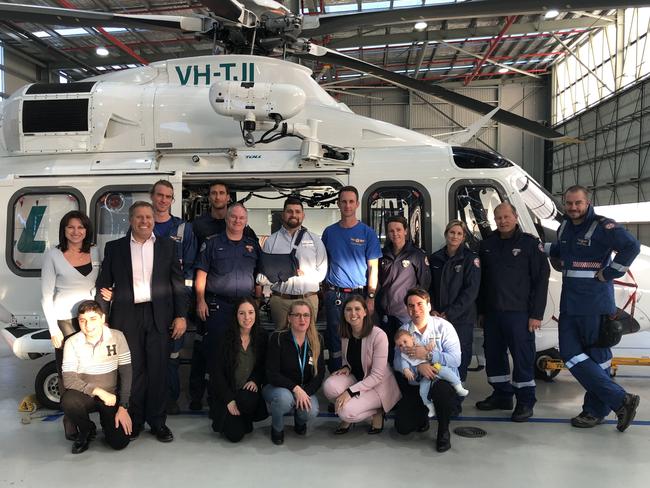 Nicholas Hanania, hand in sling, with his family and the Toll Ambulance crew, paramedics and doctors who attended to him. Picture: Lawrence Machado