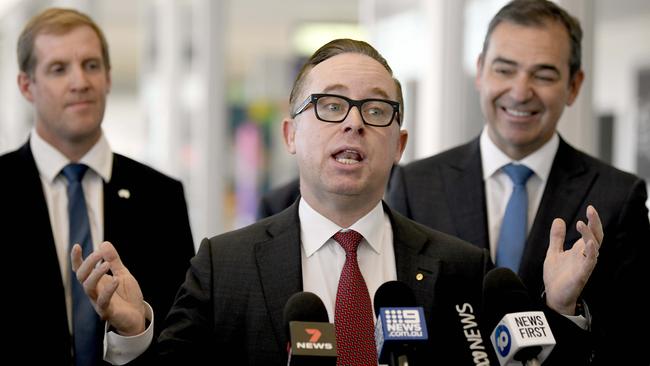 The judge said Qantas’ relationship with the union was antagonistic, noting CEO Alan Joyce (centre) had publicly labelled it “militant”. Mr Joyce is pictured with SA Premier Steven Marshall (right) and MP Stephen Patterson announcing a base to create up to 200 new jobs in Adelaide in May. Picture: Naomi Jellicoe