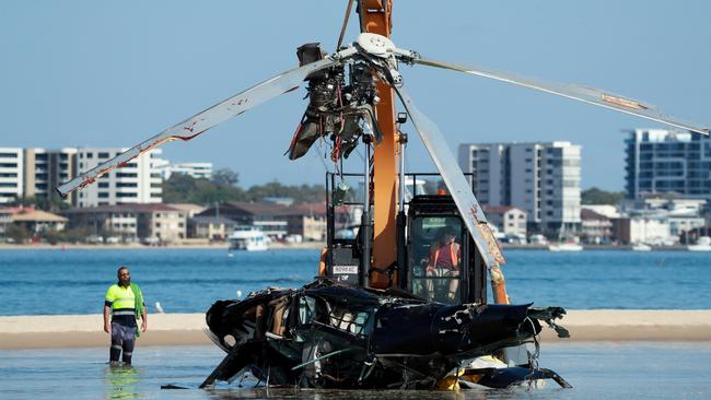 Queensland Police and ATSB Officers recover the wreckage after four people were killed and many more injured after two helicopters collided near Sea World on the Gold Coast, 03 January 2023. Picture Scott Powick