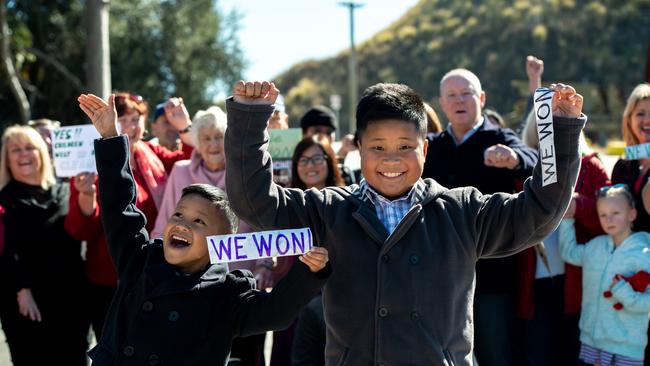 Edward and Adam Llagas pictured celebrating with The Anti-incinerator campaigners who have won their fight against the Eastern Creek plant proposed by Dial A Dump. (AAP Image Monique Harmer)