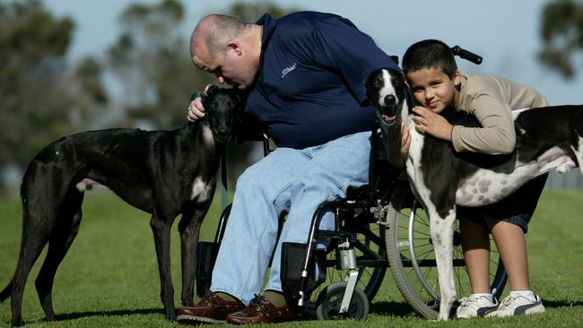 Greyhound owner Tyler Stone and son Jacob with his runners Juddy and Axe Handle.