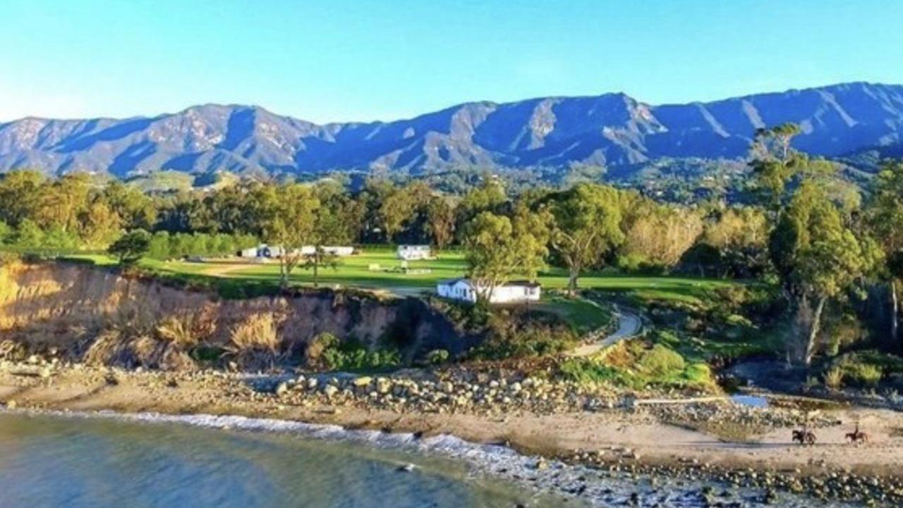 The stunning home sits on 1.4 acres of land and boasts a main house and two additional homes, which all offer sweeping views of the Pacific Ocean. Picture: costner