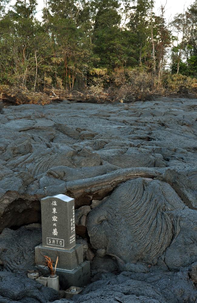 The gravestone has somehow managed to avoid being smothered by lava. Picture: AP/US Geological Survey.