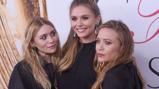 Elizabeth Olsen (centre) and Mary-Kate and Ashley Olsen at the 2016 CFDA Fashion Awards.