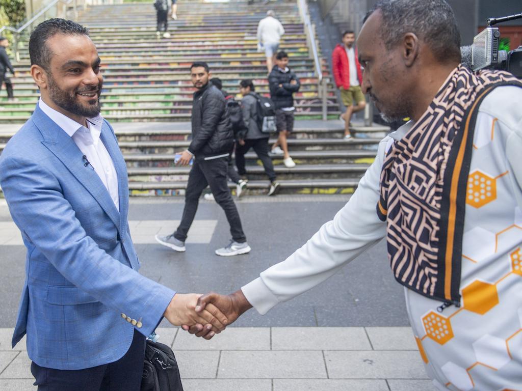 Mr Ouf greets a member of the public in Auburn on Tuesday. Picture: NewsWire