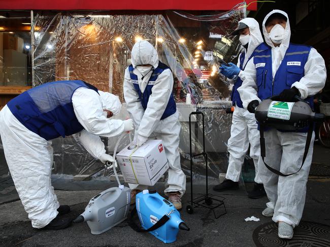 SEOUL, SOUTH KOREA - FEBRUARY 24: Disinfection professionals wearing protective gear prepare to disinfect against the coronavirus (COVID-19) at a traditional market on February 24, 2020 in Seoul, South Korea. South Korea has raised the coronavirus alert to the "highest level" as confirmed case numbers keep rising. Government reported 161 new cases of the coronavirus (COVID-19) bringing the total number of infections in the nation to 763, with the potentially fatal illness spreading fast across the country. (Photo by Chung Sung-Jun/Getty Images) *** BESTPIX ***