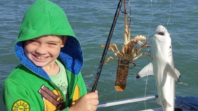 Bailey young was rapt when he managed to land both a crayfish and a shark recently