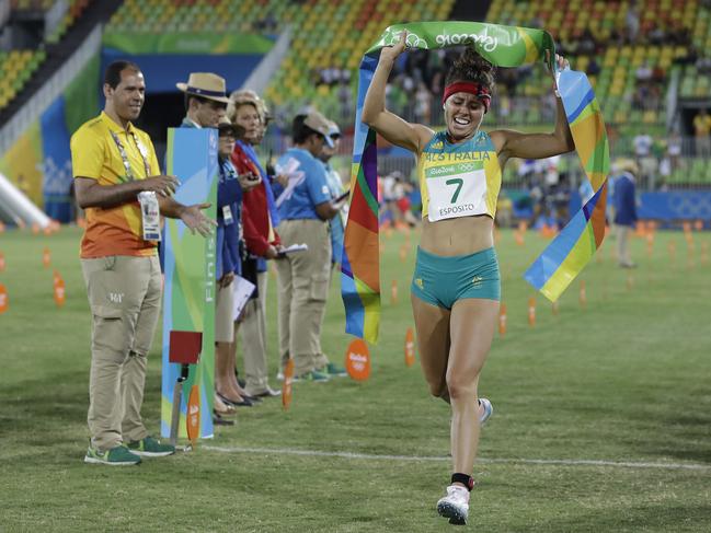 Chloe Esposito of Australia crosses the finish line to win the gold medal in the women’s modern pentathlon.